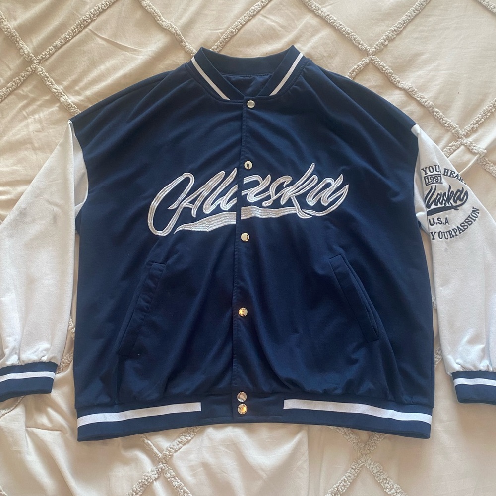 Dark blue and white bomber style jacket, material is on the thinner side.